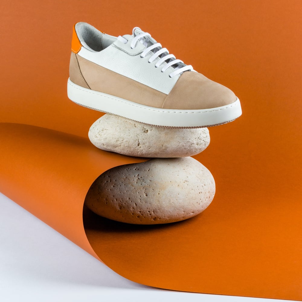 A pair of sneakers resting on a stack of rocks